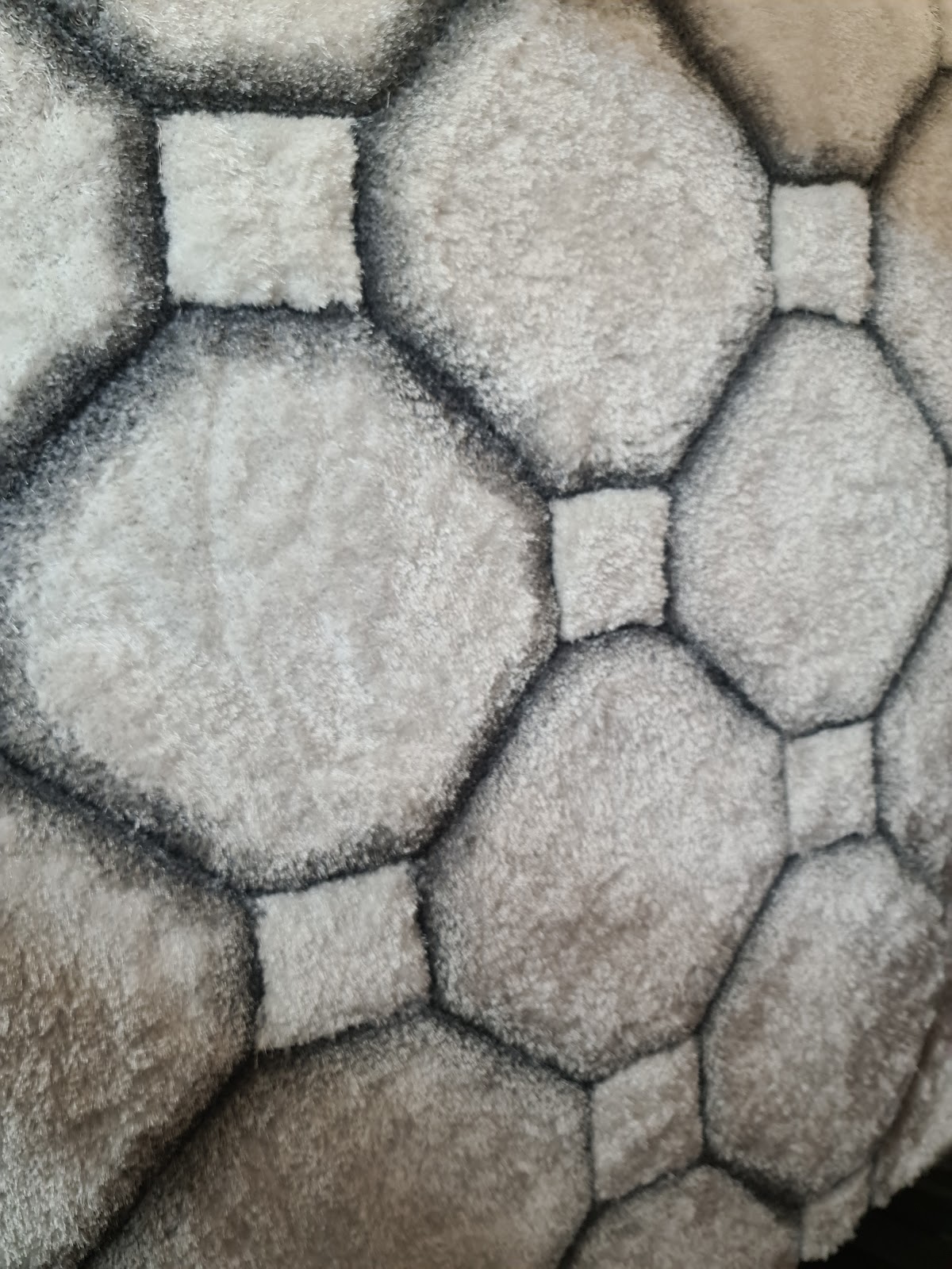 Soft grey textured rug close up